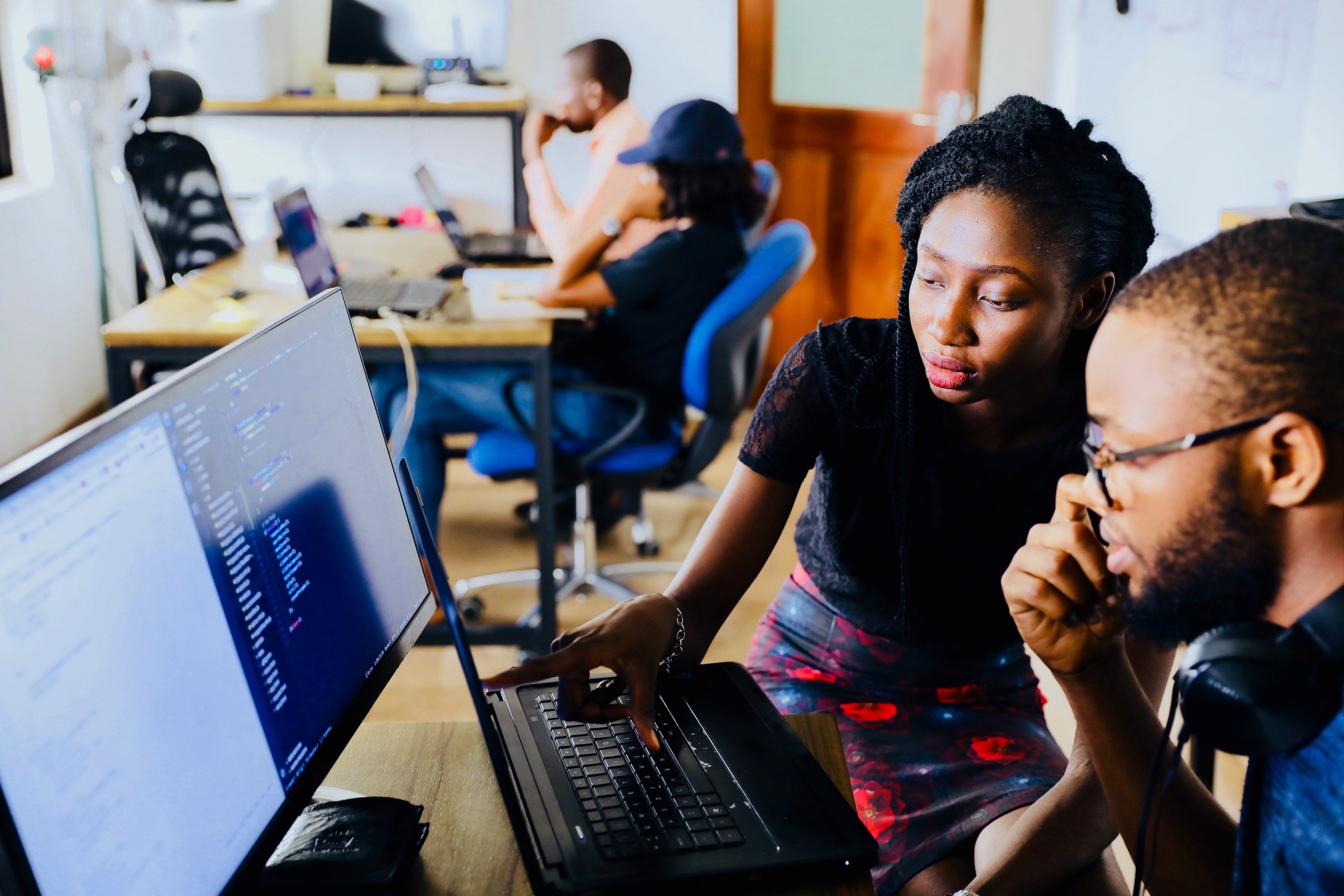 Two people working together on a laptop