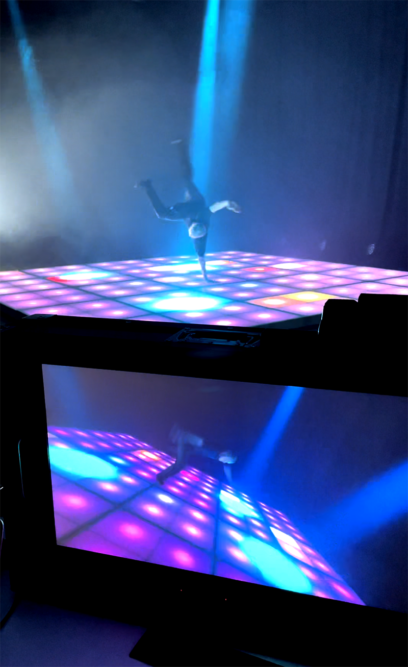 Breakdancer on an illuminated floor filmed for the Flow video