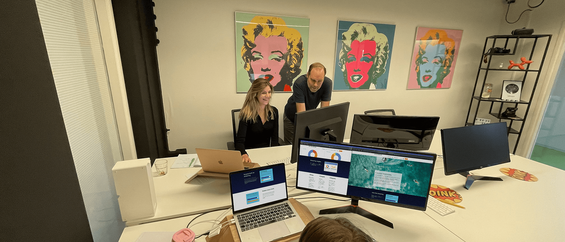 Jet-Stream office with Warhol-style art and workstations