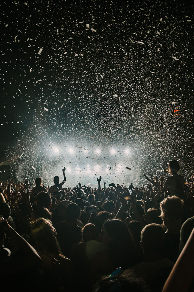 Concert crowd with confetti, increasing viewer engagement with live streaming
