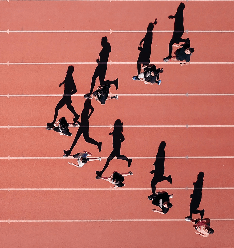 Aerial view of runners on a track, illustrating marathon streaming