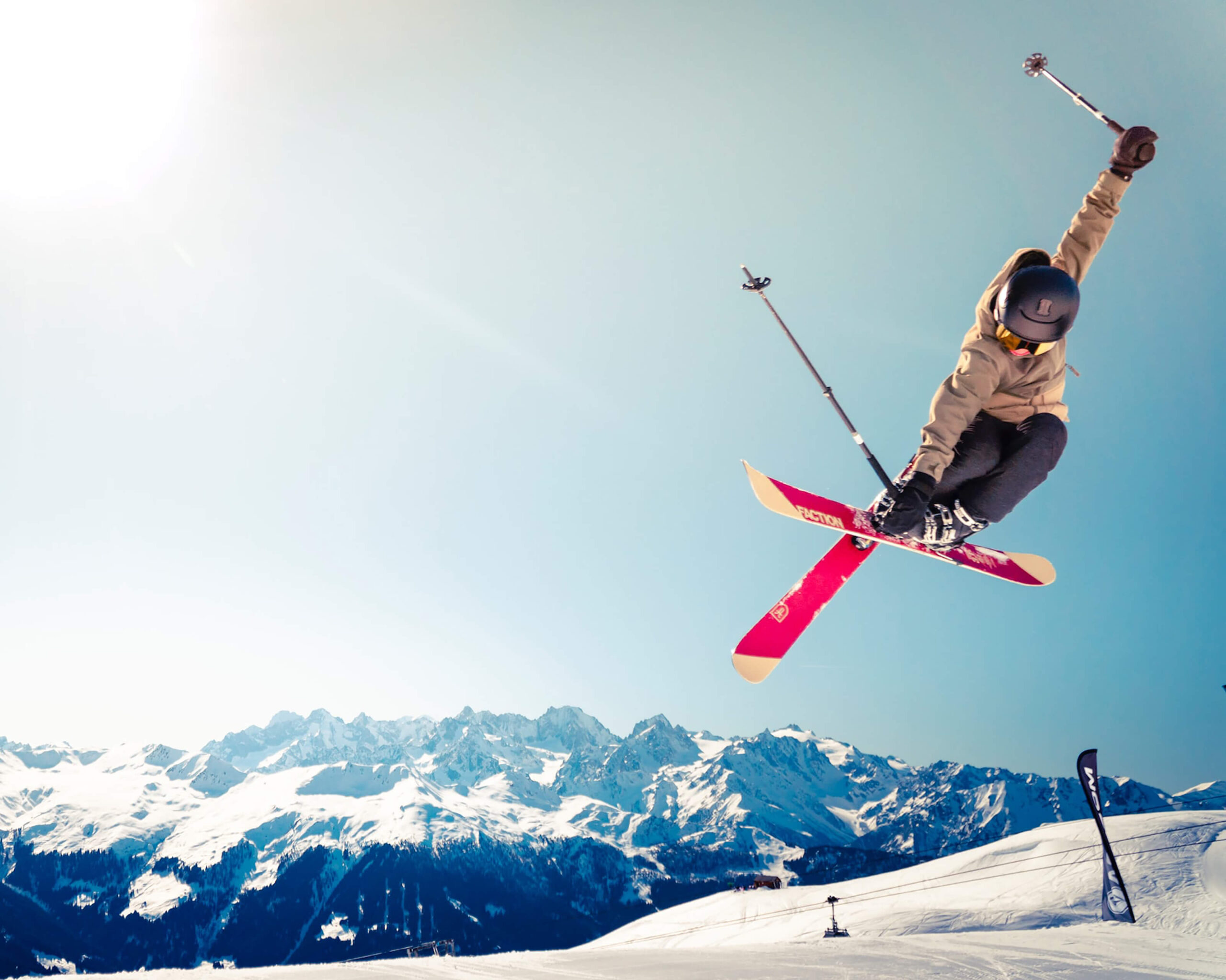 Skier jumping against snowy mountains, illustrating sports streaming