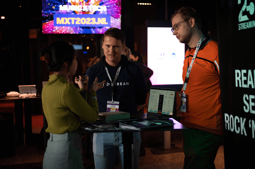 Jet-Stream team at a stand talking with visitors, your strategic streaming partner