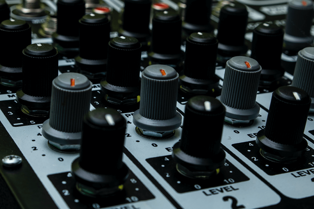 Close-up of audio mixer knobs, illustrating being in control of streaming