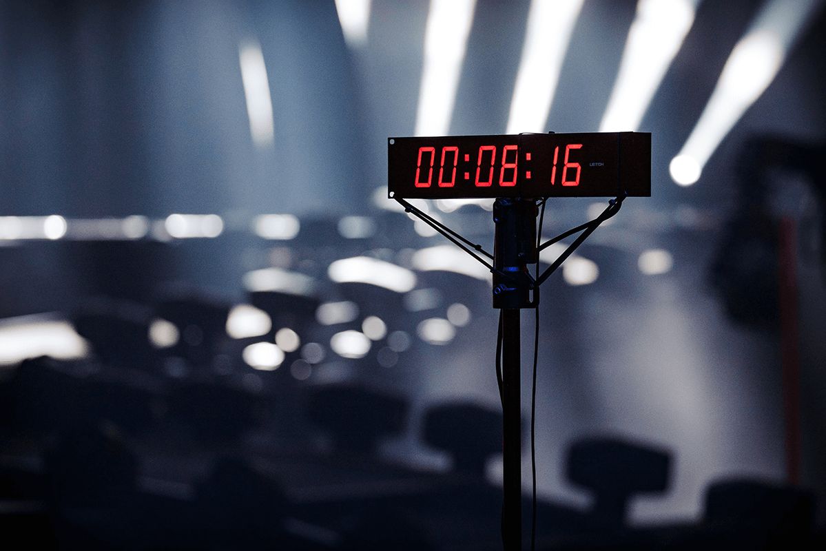 Red studio clock in a broadcast setting, broadcast grade streaming