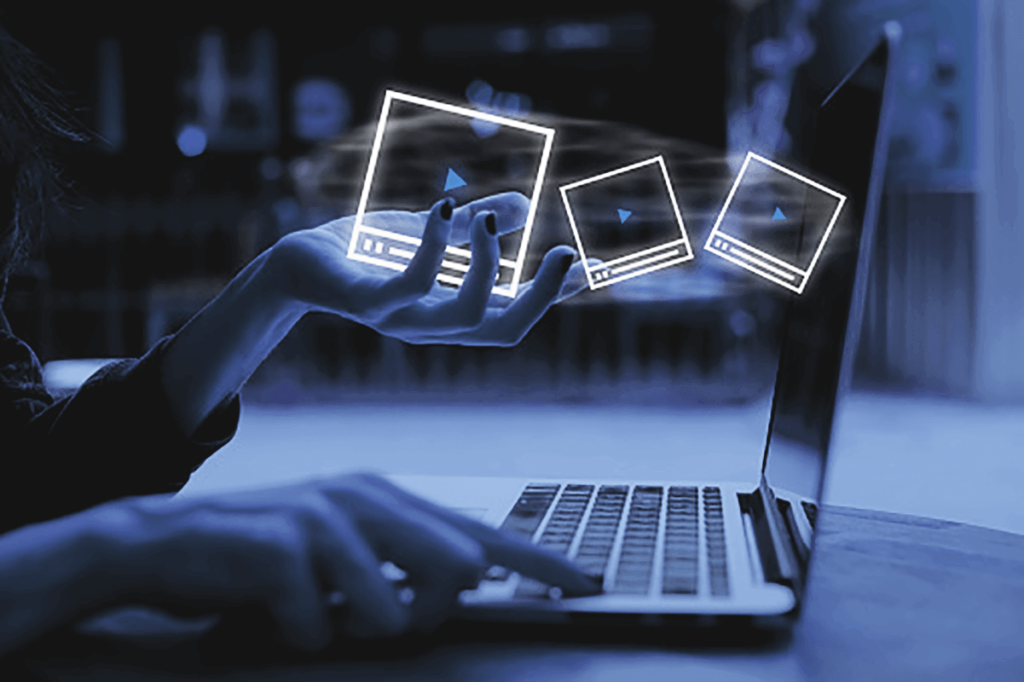 Hands interacting with floating screens above a laptop, illustrating interactive video