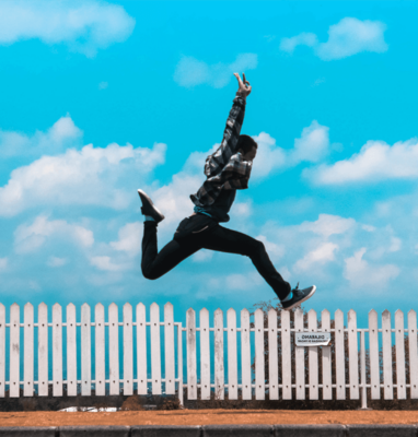 Person jumping over a fence, illustrating overcoming publishing challenges