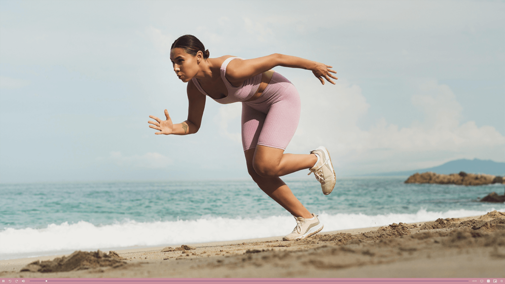 Runner on a beach in a branded video player, branded player for commercial videos