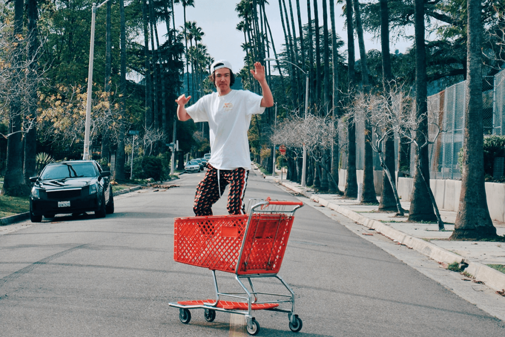 Man jumping behind a shopping cart, illustrating fun video stories for e-commerce social media