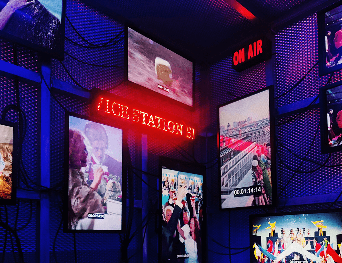 Room full of glowing screens and an On Air sign, illustrating MaelStrom OTT live channels