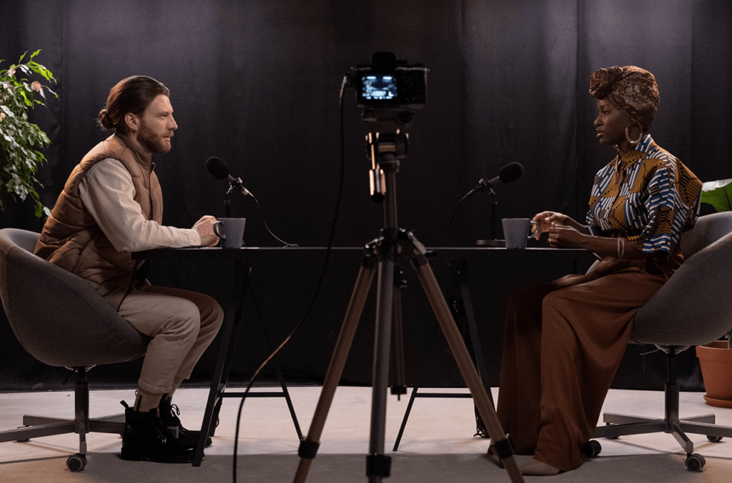 Two people recording a video podcast in a studio