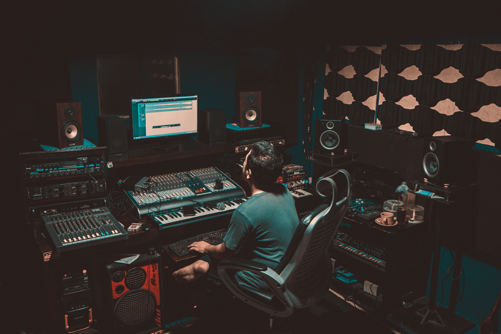 Radio presenter at a mixing desk in a radio streaming studio