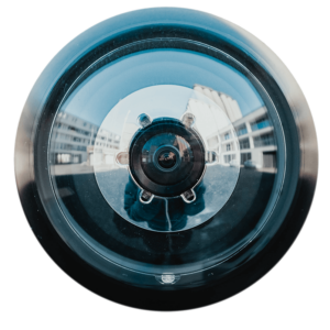 Close-up of a camera lens reflecting buildings, illustrating video quality