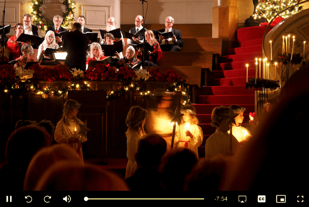 Choir service with candles in a video player, illustrating church live streaming