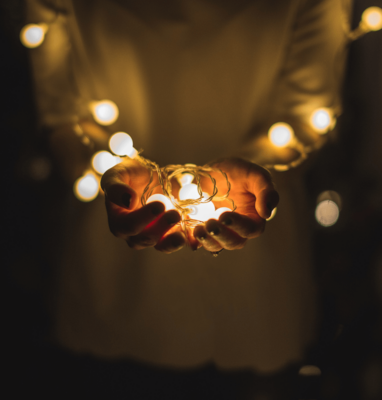 Hands holding small lights, streaming for faith-based organizations