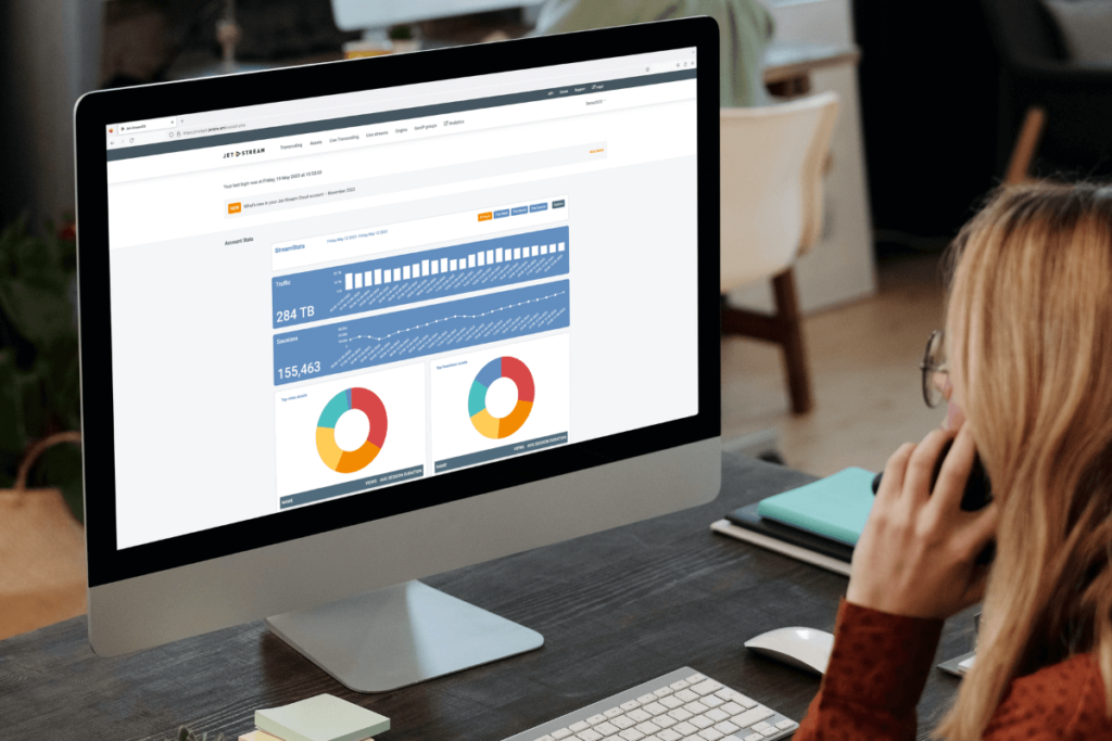Woman viewing the StreamStats analytics dashboard on a computer