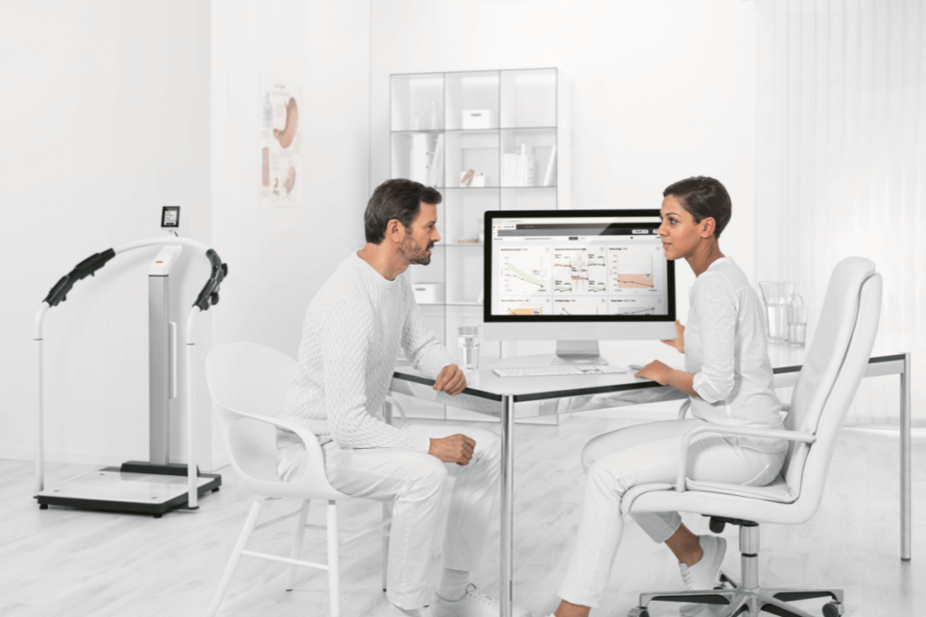 Doctor and patient in a consultation at a computer, illustrating video for healthcare