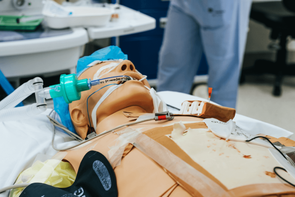 Medical training mannequin in a simulation room for educating healthcare specialists