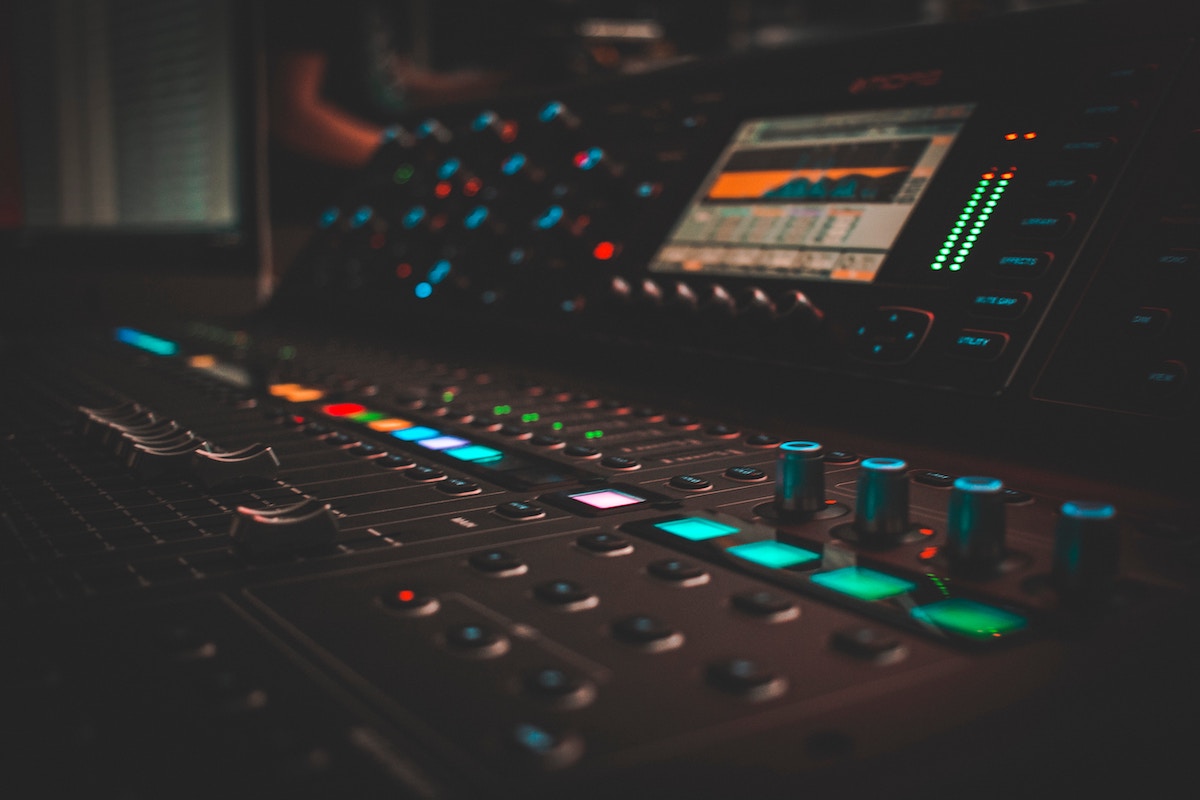 Close-up of a lit audio and video mixing console