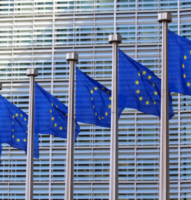 EU flags in front of a European Commission building, European sovereign cloud services
